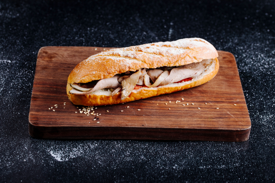 baguette sandwich with ham wooden board