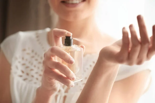 depositphotos 150318200 stock photo woman with bottle of perfume